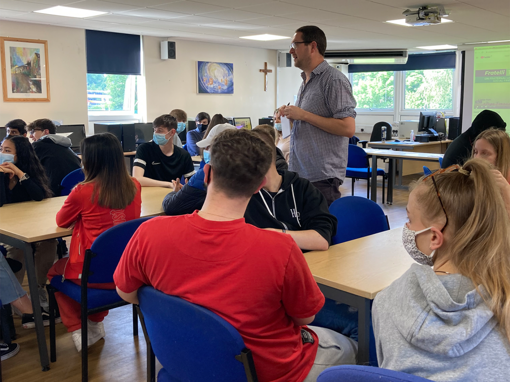 James addresses a room of students
