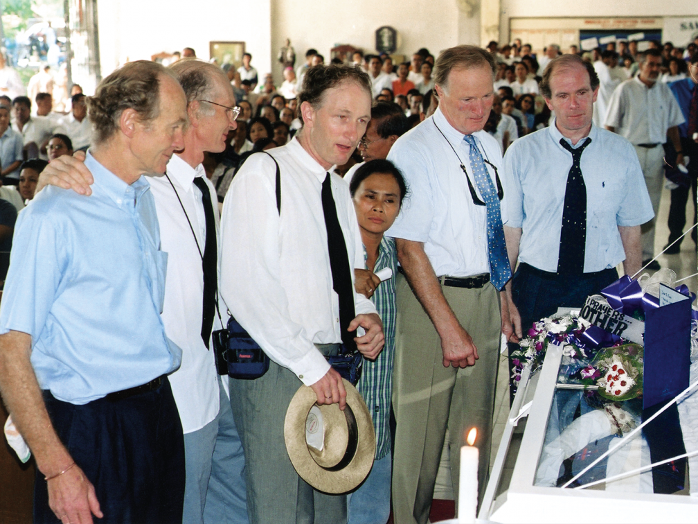 five men and one small lady at a funeral mass