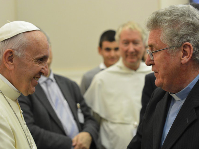 Pope Francis shakes hands with Sean McDonagh