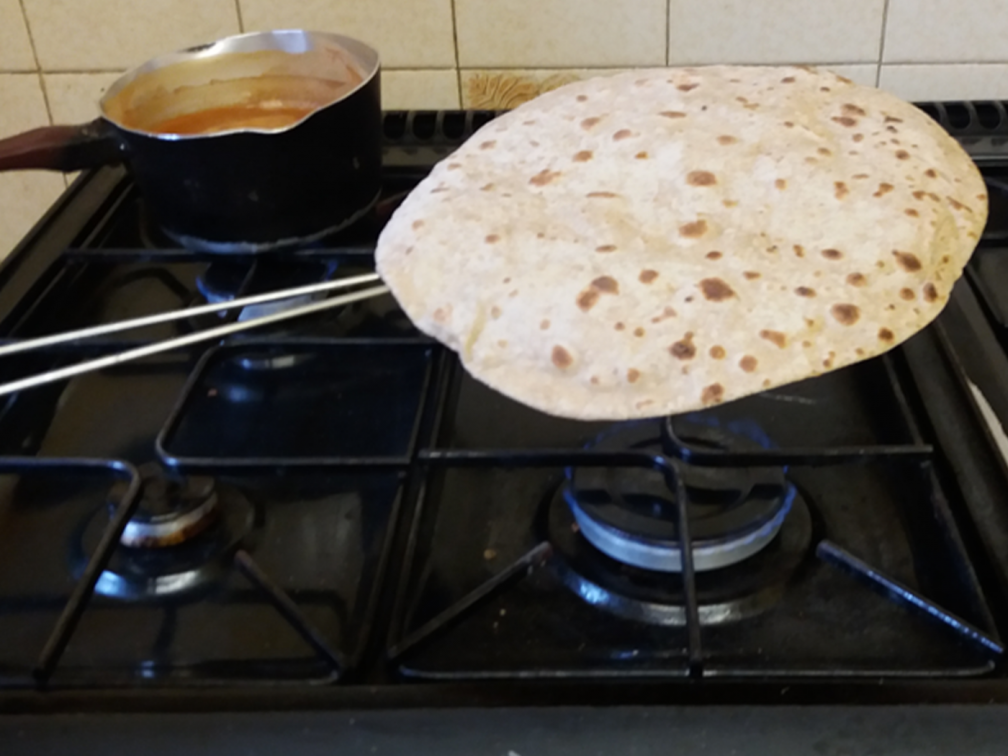 chapatti being made on a gas hob