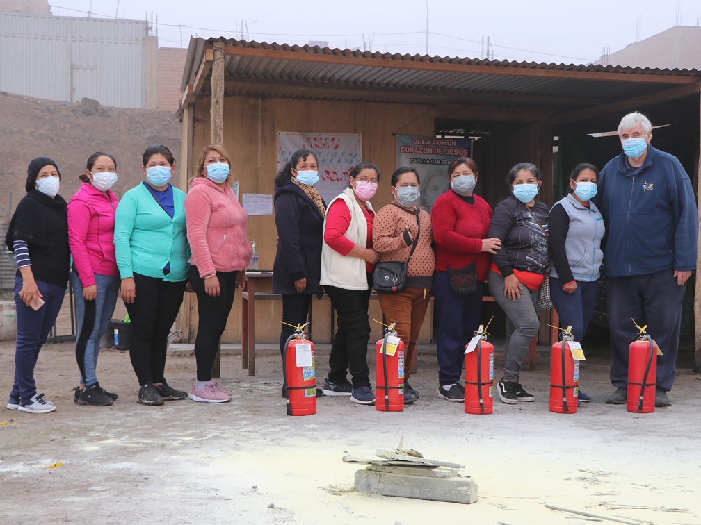 Females stand with Ed Oconnell and fire extinguishers