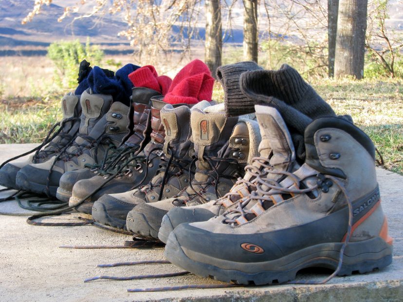 several pairs of walking boots and socks