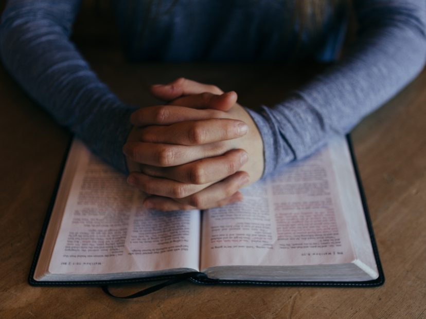 bible and praying hands