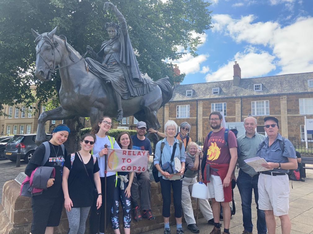 group of participants stand in front of The Fine Lady Statue at Banbury Cross