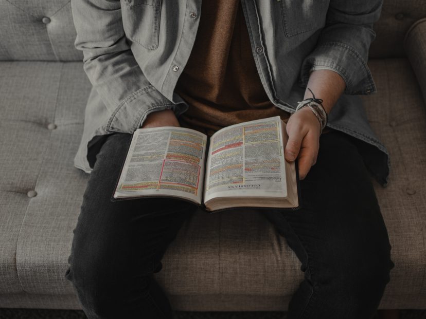 male holding a bible in his lap