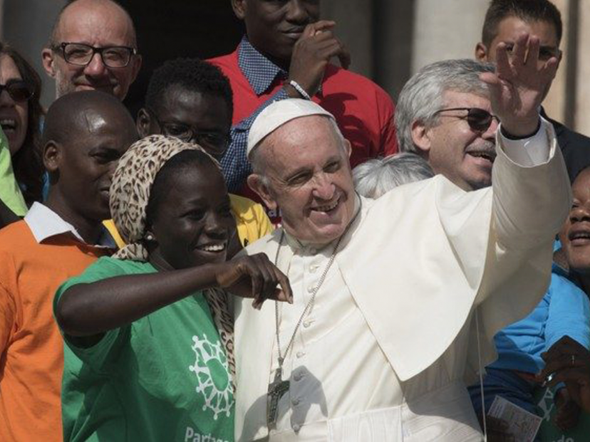 pope with migrant people