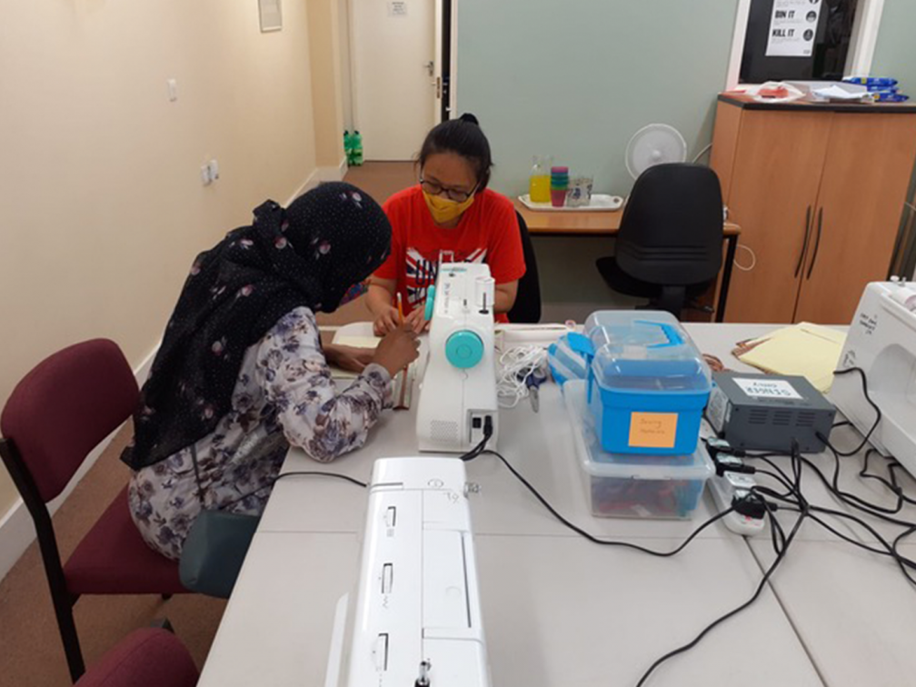 two women at a sewing machine