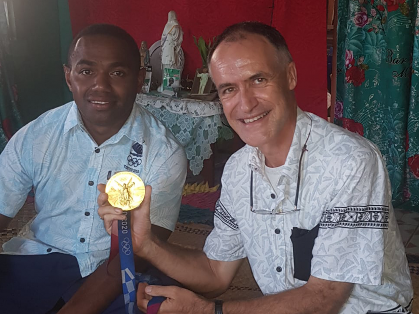 Waisea and Fr Pat who holds the gold medal.