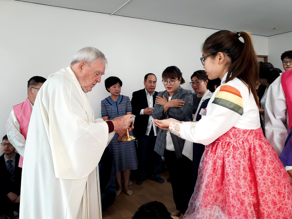 priestgives communion to young girl and her friends