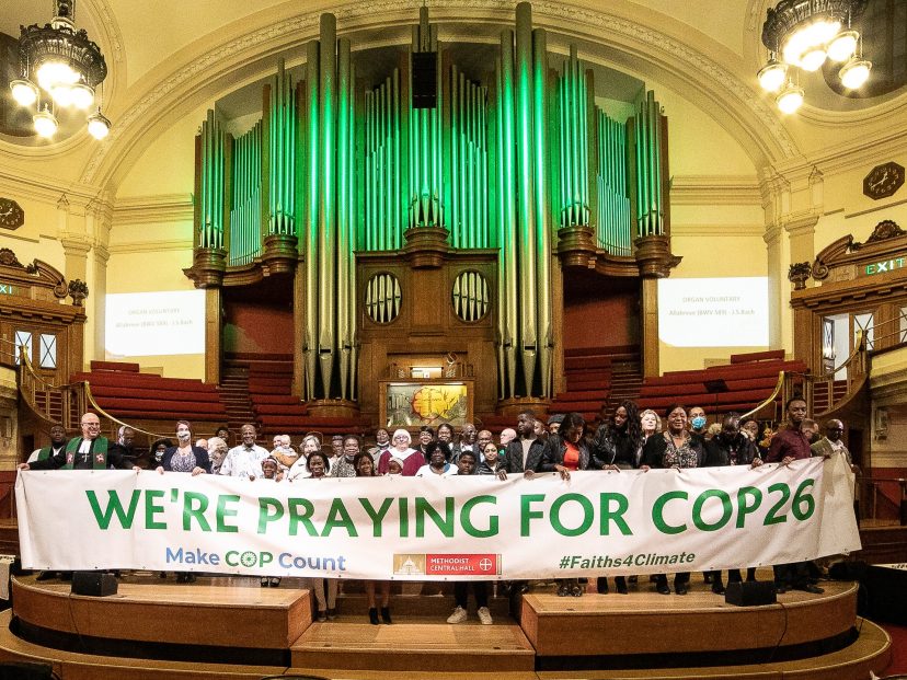 crowd holding a banner