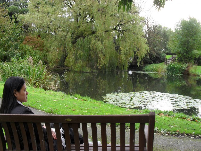 female looks out over green and lakes