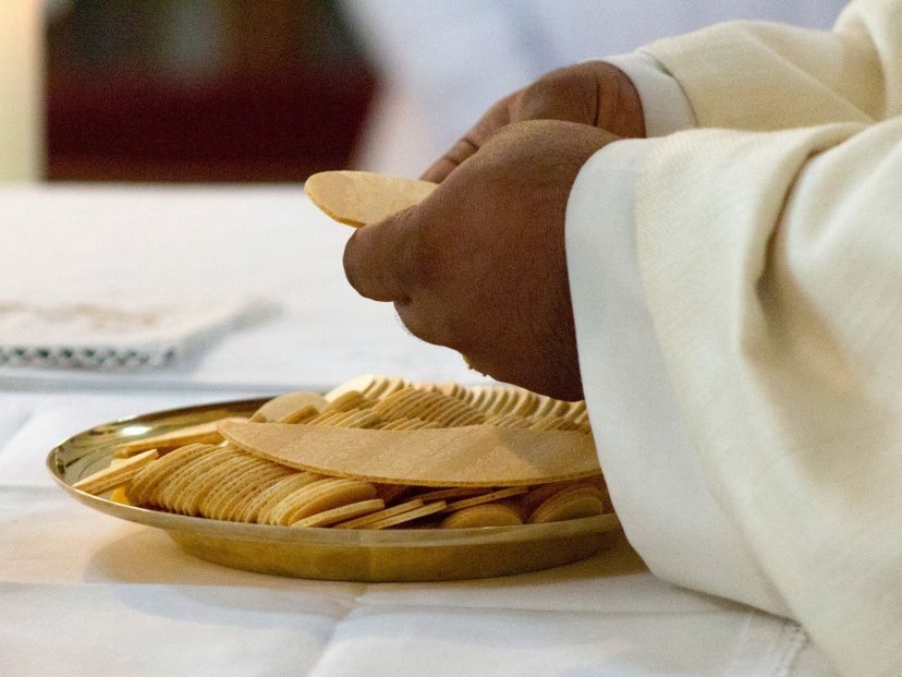 priest with eucharist