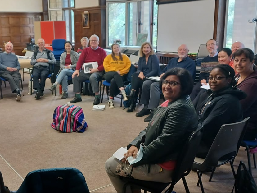 people sat in circle smile at camera