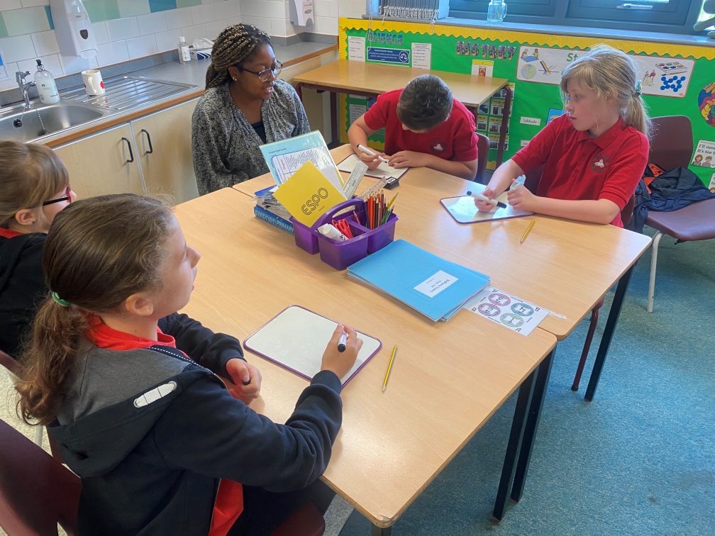 female and students at a classroom table