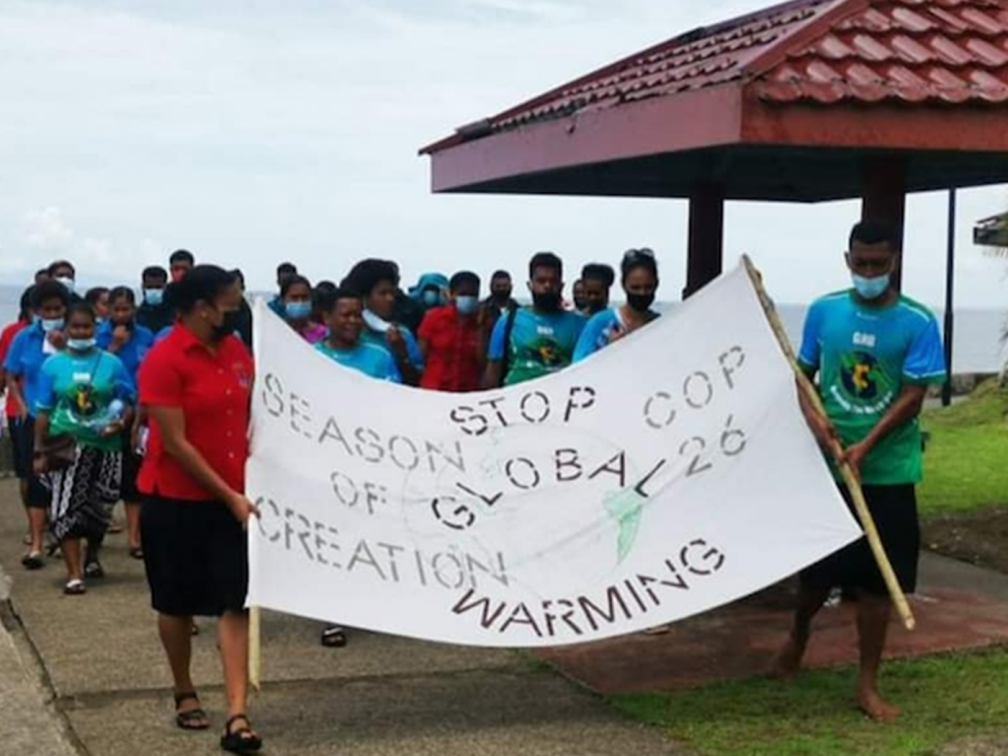 group of people with COP26 banner