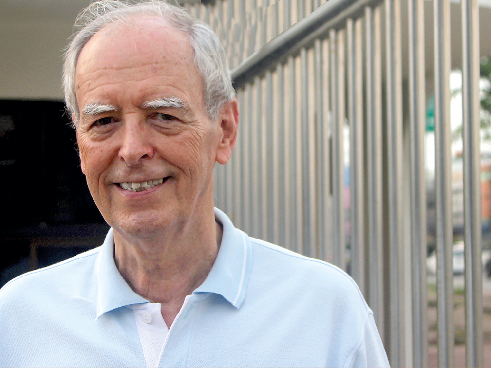 male in front of prison bars