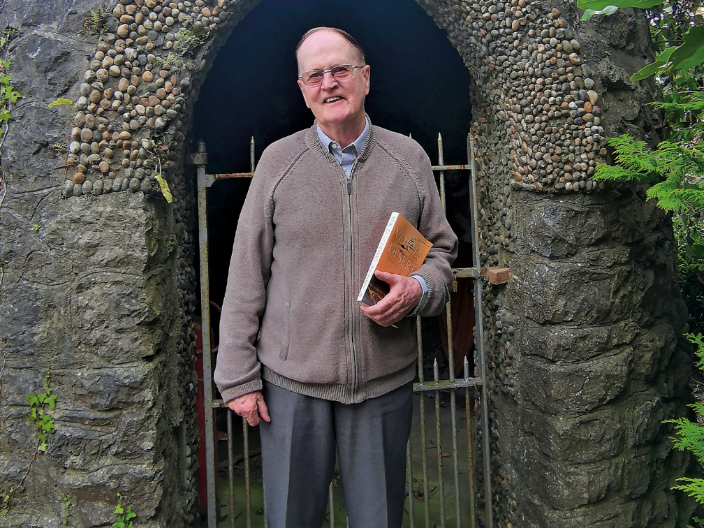 Fr. Hugh holding his book