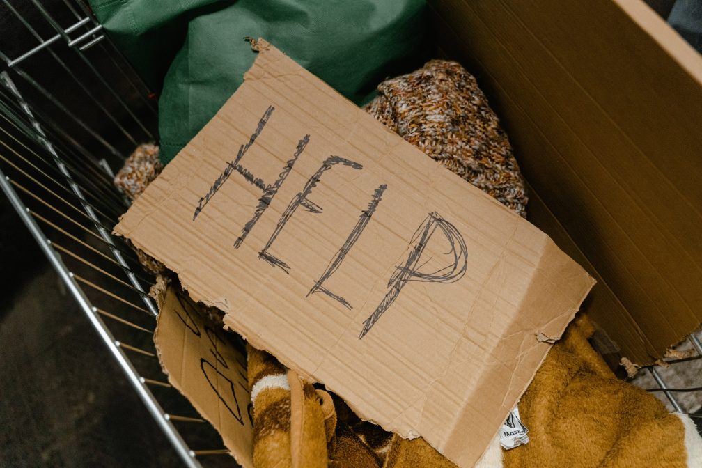 the word 'help' written on cardboard