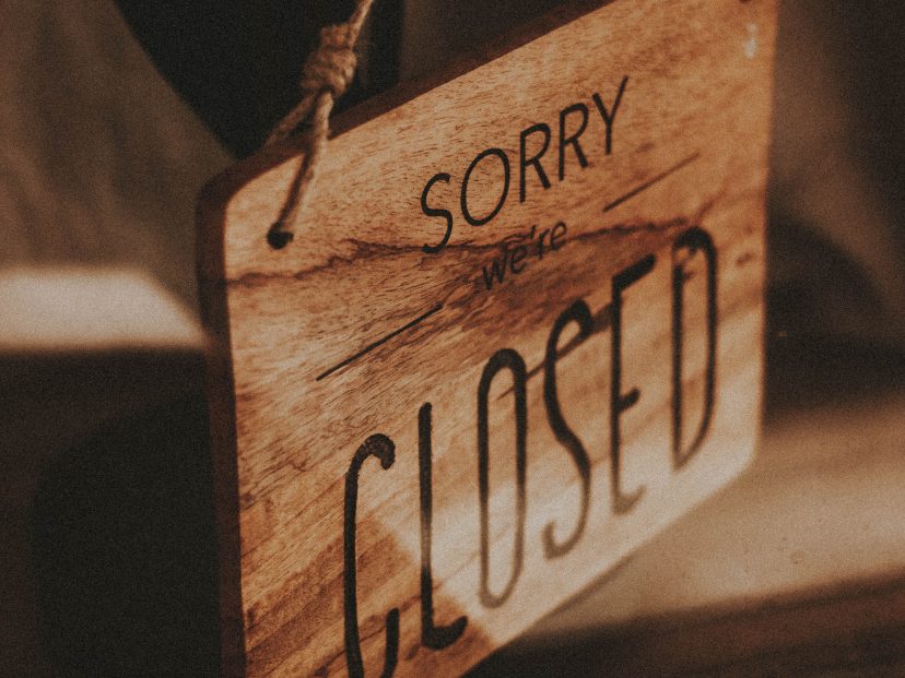 hanging wooden 'sorry we're closed' sign