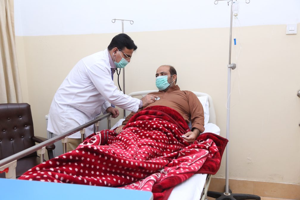 male nurse listens to the chest of a male patient