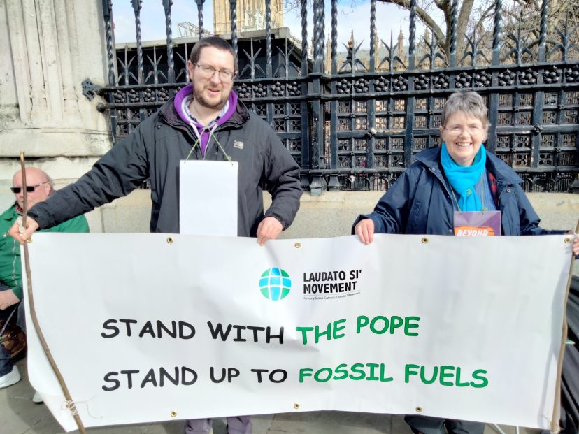 two people hold a banner