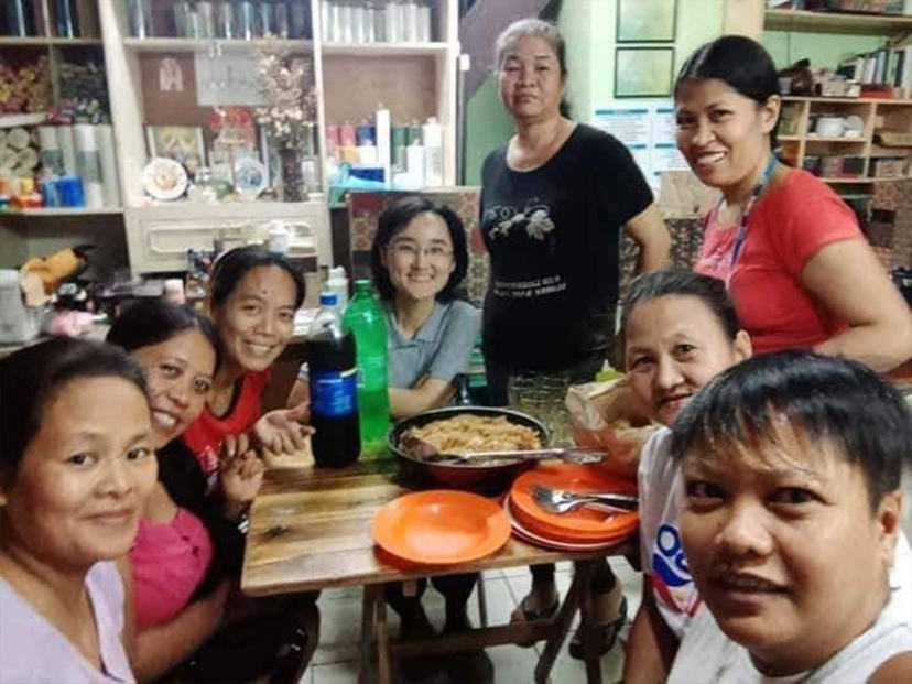 females crowd together and look at the camera