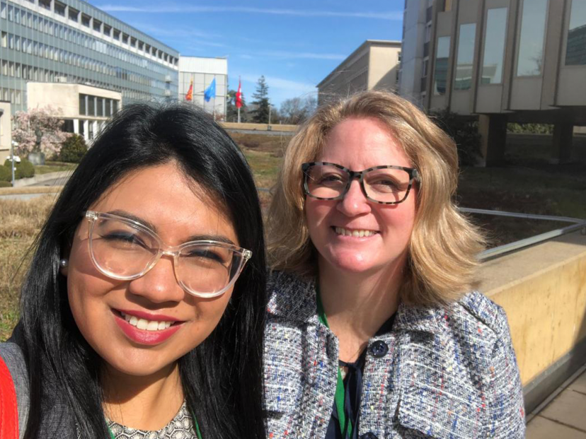 two females smile at the camera