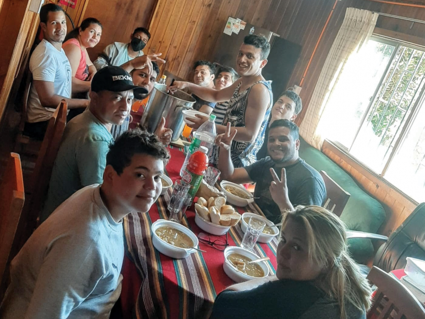 group of people enjoy a meal around a table