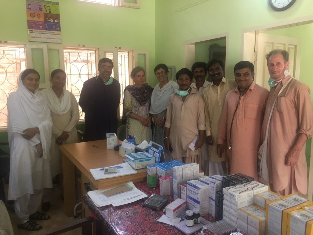 people behind a table with medicines