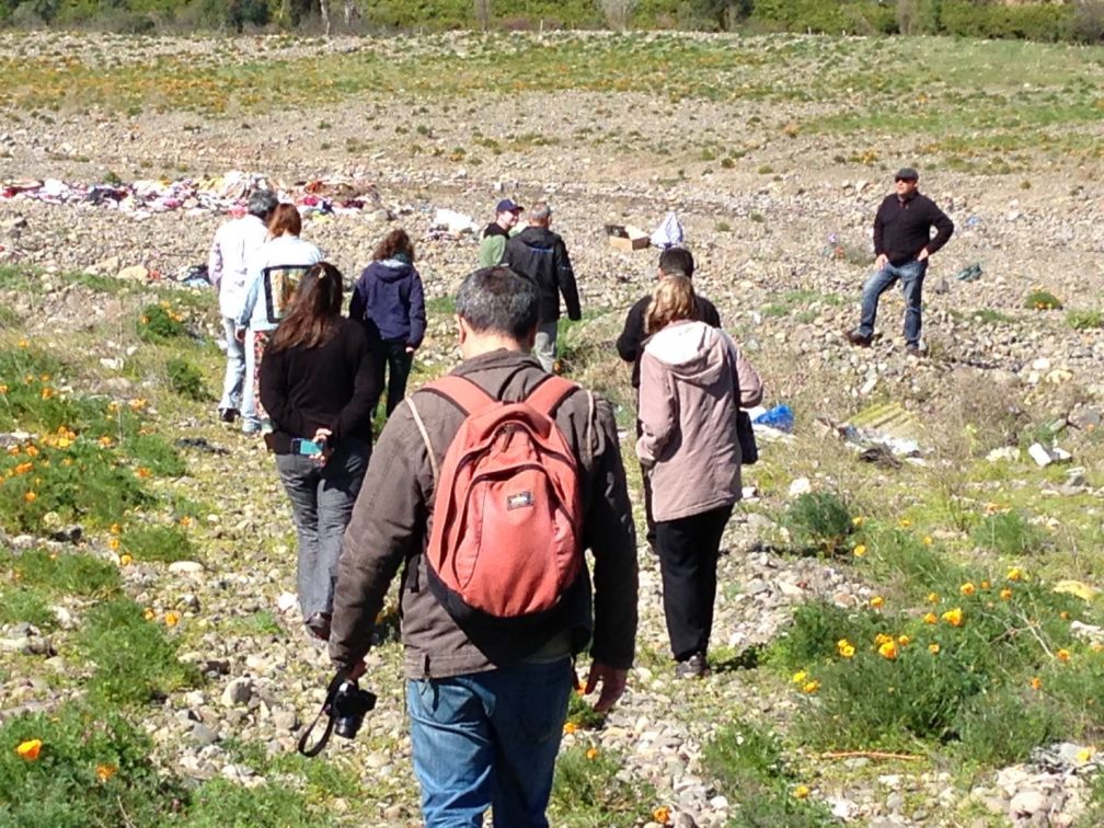 dried river bed and rubbish bags