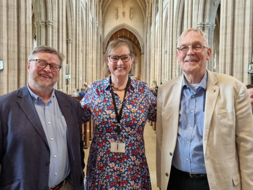 three people smile at camera