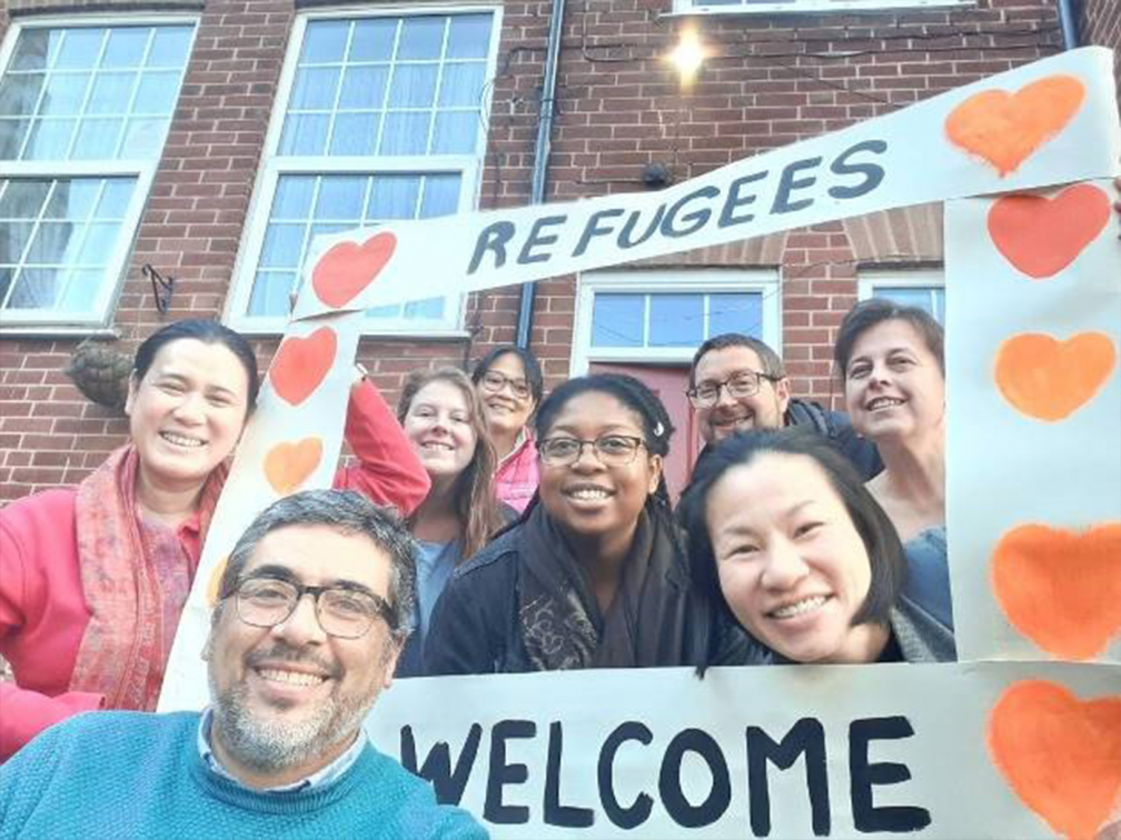 Refugees welcome sign held by Columbans