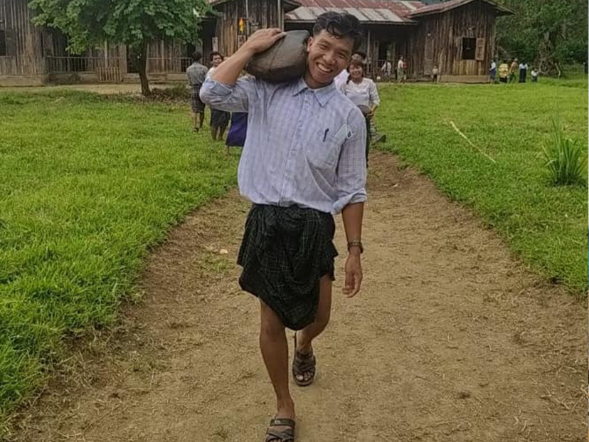 Zawng Dau carries books and supplies for the village school