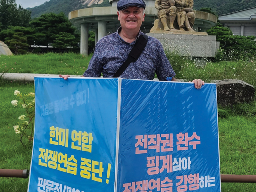 Priest holds posters