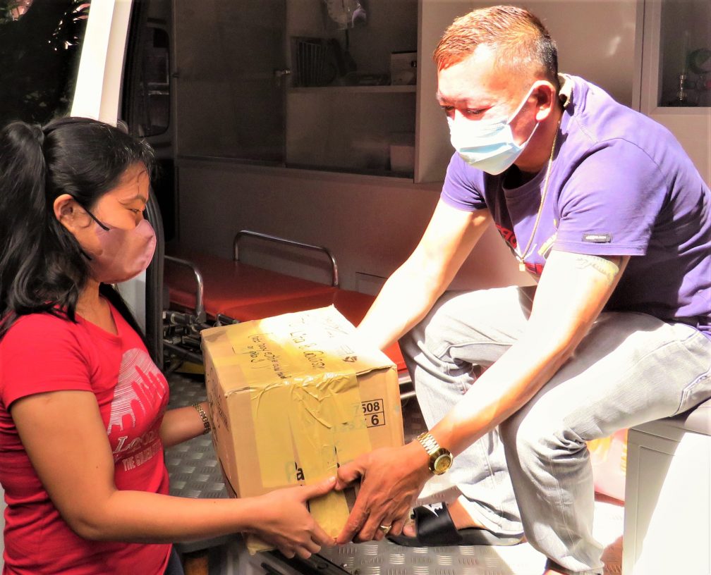 Volunteers load an ambulance with supplies