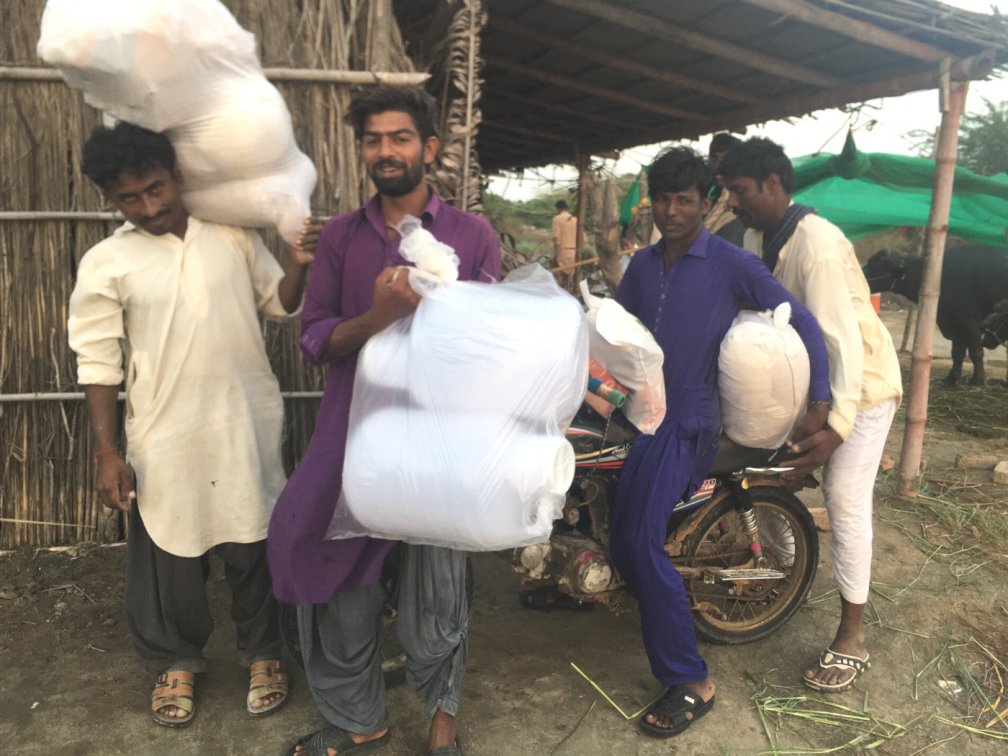 Happy village people receiving flood relief aid.