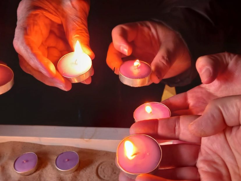 hands hold tealights