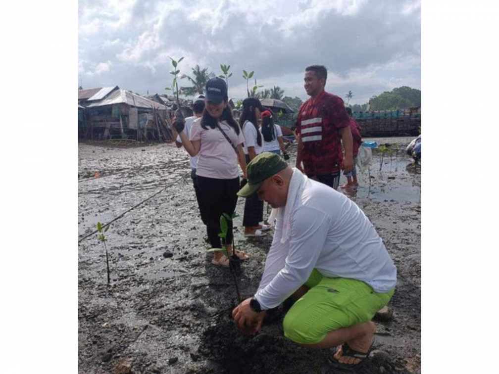 John Din planting mangroves in the Philippines