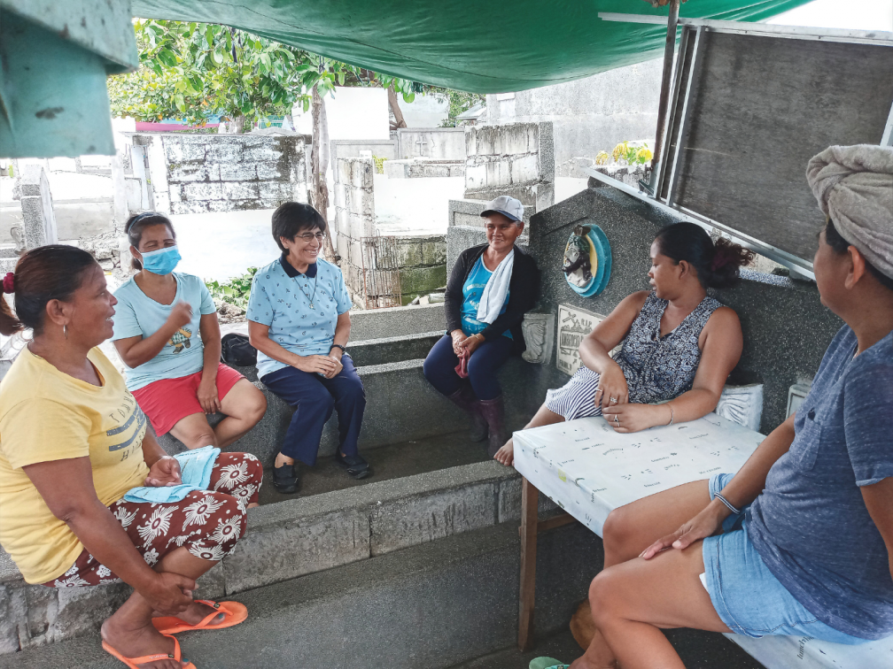 Sr Eufrasia Garcia chats with mothers in the cemetery in the parish of Pasay