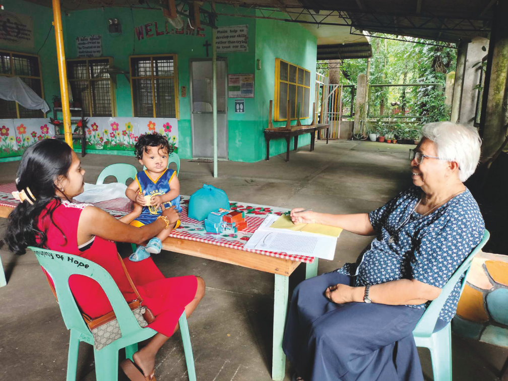 Sr. Cecilia Cuizon advises a mother in Community of Hope