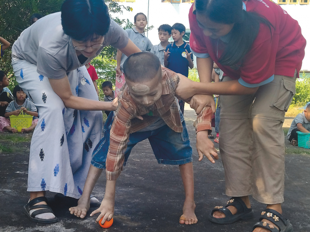 Sr. Enda Im and co-worker support a child with special needs