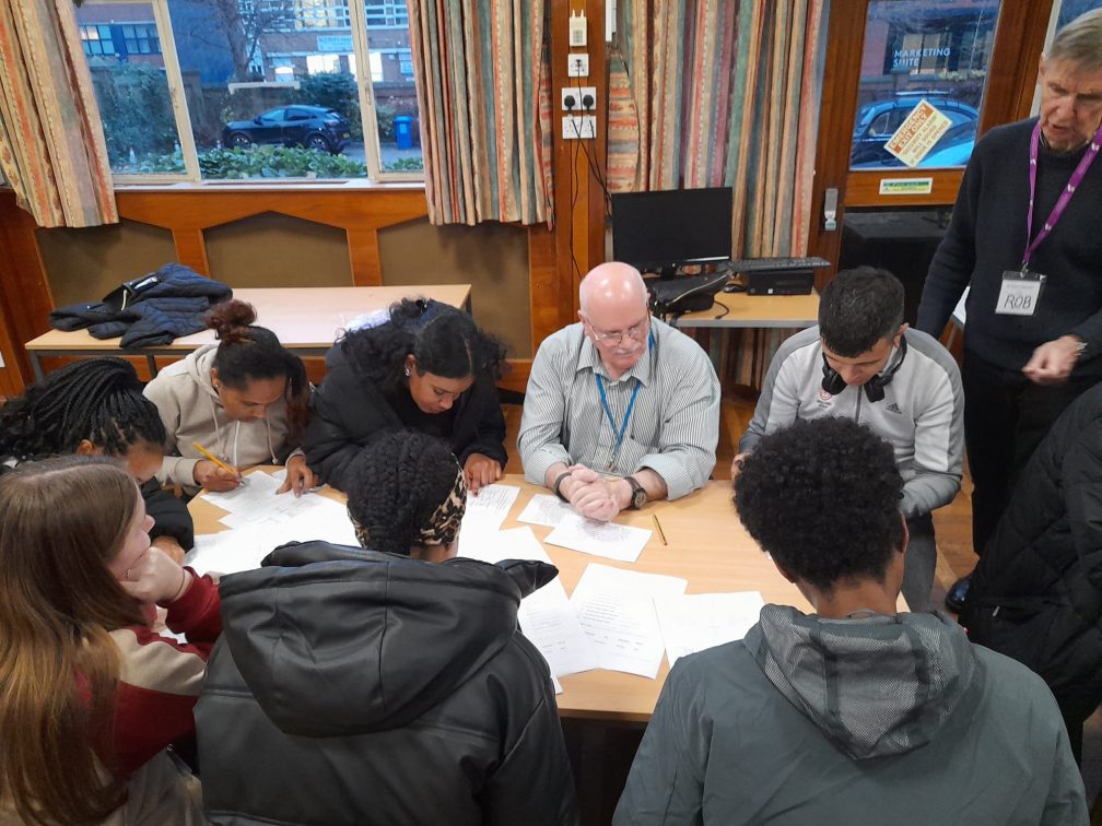 Abi supports the running of an English lesson for students at St. Chad's Sanctuary