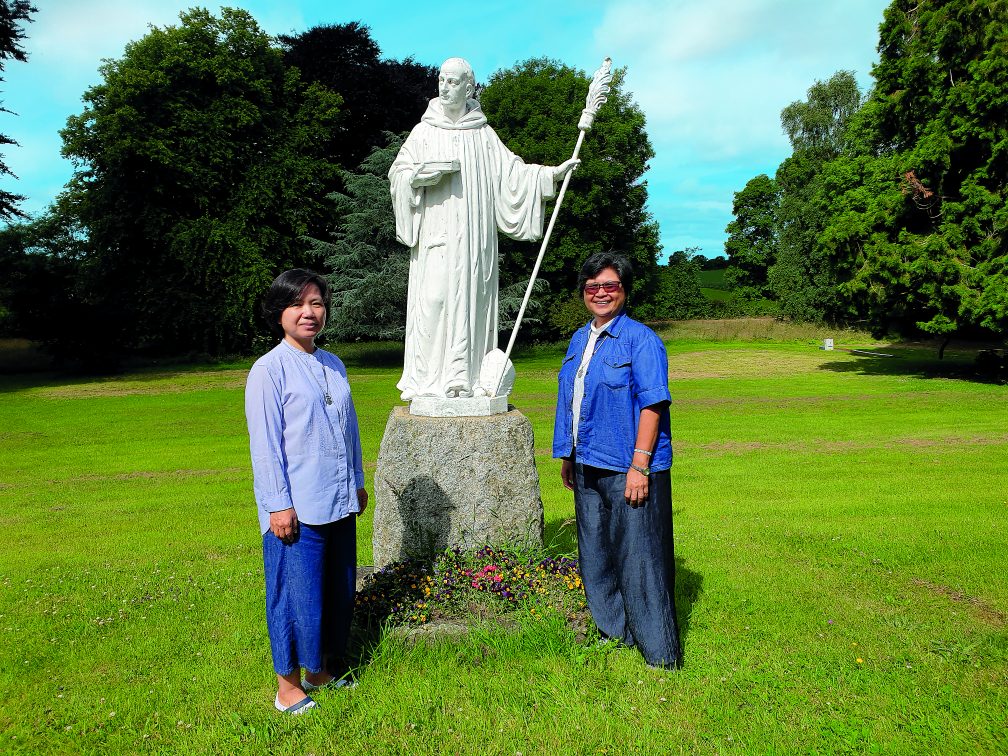 Sr. Hasuk with Sr. Vergie in front of the statue of St Columban in Magheramore, Ireland. Photo: Sarah Mac Donald