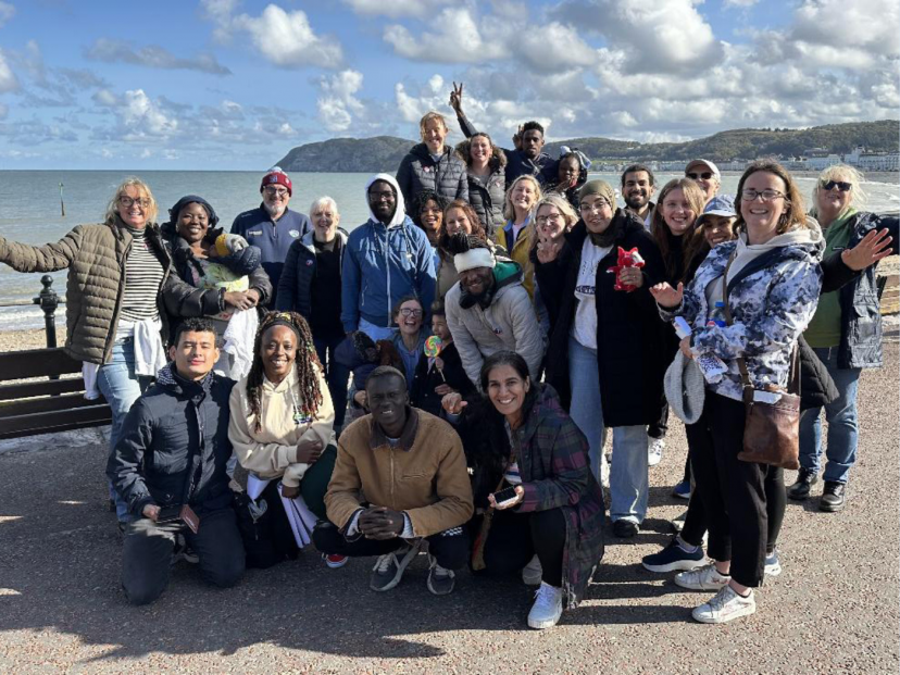 ‘Festival of Encounter’ in October 2024, where headteachers and asylum seekers came together for a residential weekend. Photo taken after sharing fish and chips on the beach, a British Tradition. Credit: Julie-Anne Tallon.