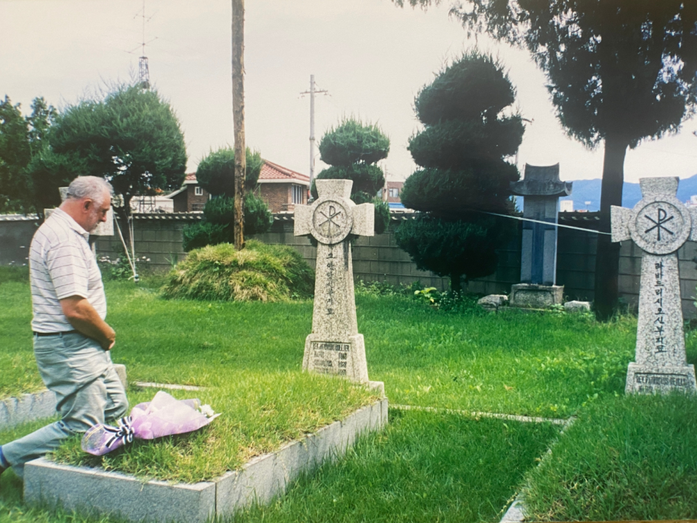 Fr. Ray at his uncle Tony's grave outside Chunchon Cathedral in Korea during a visit in 2000.