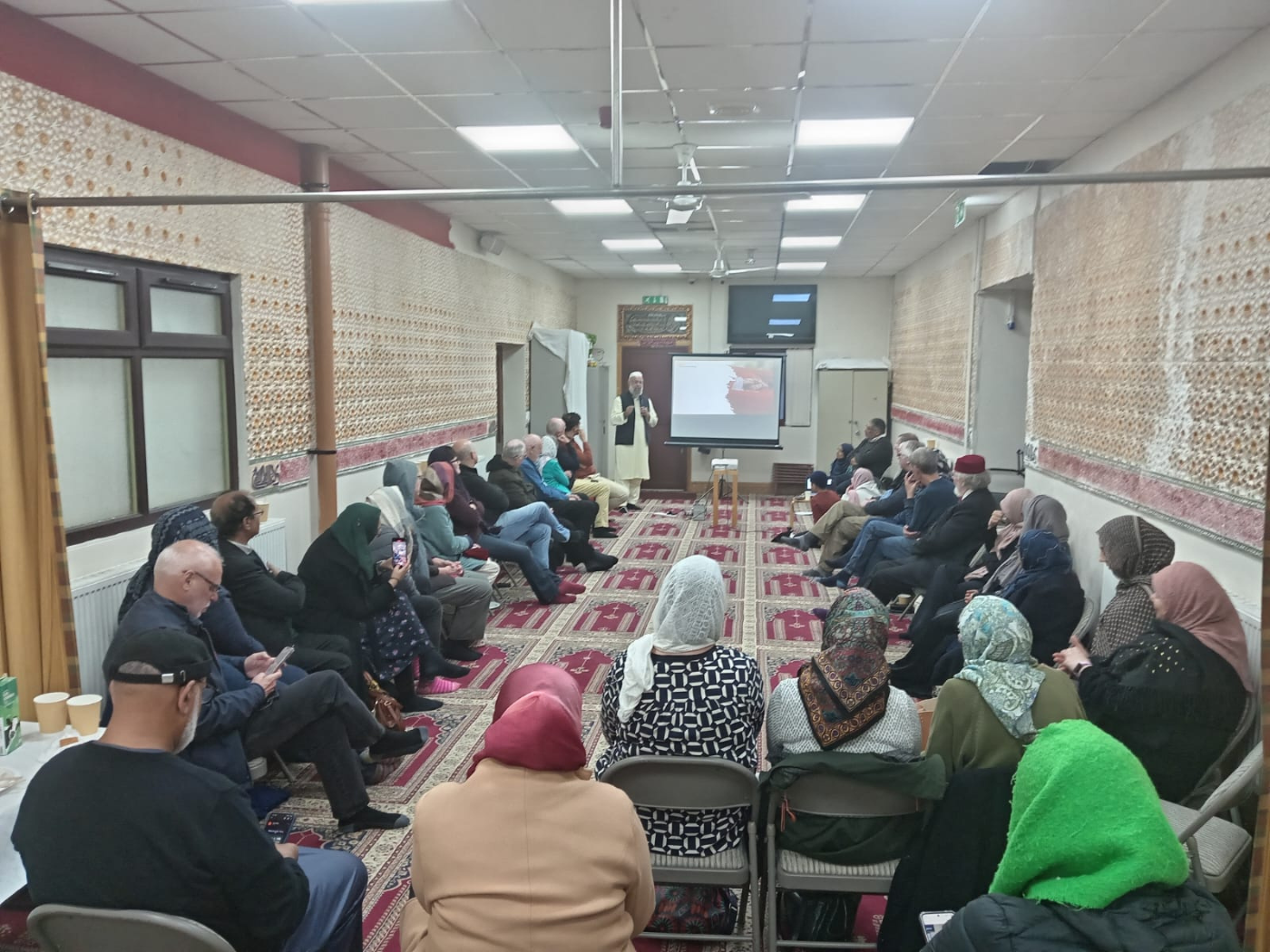 Imam Mohammad Asad MBE addressing the group
