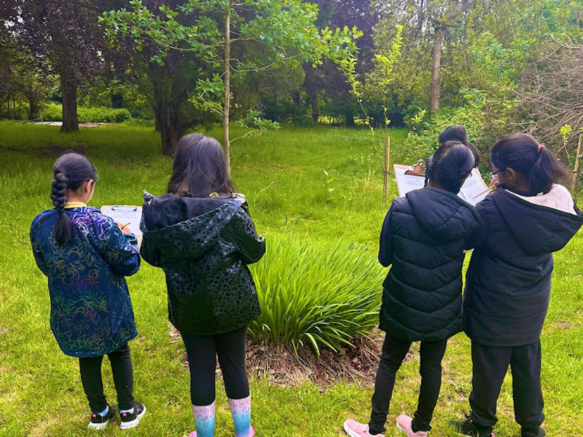 Young students in the grounds of Solihull participate in Flourish activities