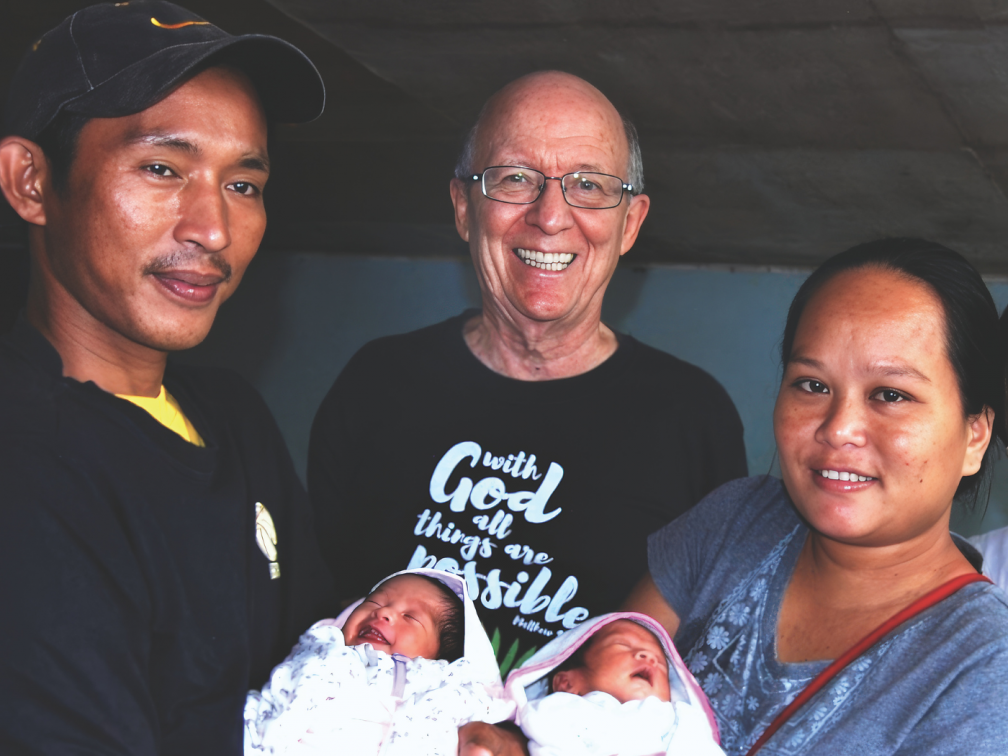 Fr. Vincent with Juvelyn Vargas and her husband Raffy and their twin daughters, Rhea Faith and Rhea Hope