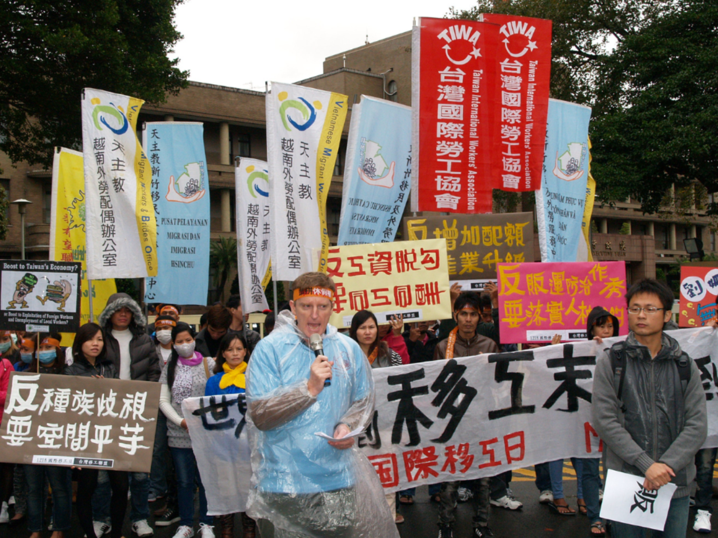 Fr. Peter speaking at a protest for migrant workers