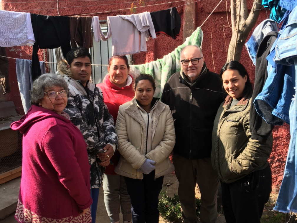 Fr. Dan Harding with Chilean Social Worker ( far left) at the Columban Migrant House with a Venezuelan family